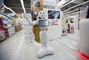 SoftBank Corp's human-like robot named "Pepper" gestures as it introduces Nestle's coffee machines at an electric shop in Tokyo December 1, 2014. Nestle SA started to use robots to help sell its coffee makers at electronics stores across Japan, becoming the first corporate customer for the chatty, bug-eyed androids unveiled in June by tech conglomerate SoftBank Corp. The waist-high robot, developed by a French company and manufactured in Taiwan, was touted by Japan's SoftBank as capable of learning and expressing human emotions, and of serving as a companion or guide in a country that faces chronic labour shortages. The maker of Nescafe coffee and KitKat chocolate bars plans to have the robots working at 1,000 stores by the end of next year, a Nestle official said. REUTERS/Issei Kato (JAPAN - Tags: SCIENCE TECHNOLOGY SOCIETY BUSINESS TPX IMAGES OF THE DAY) *** Local Caption *** Robot mirip manusia bernama "Pepper" buatan SoftBank Corp memperkenalkan mesin kopi Nestle di sebuah toko elektronik di Tokyo, Jepang, Senin (1/12). Nestle SA mulai menggunakan robot untuk membantu penjualan mesin kopi mereka di toko-toko elektronik di Jepang, menjadi pelanggan korporat pertama yang menggunakan android cerewet yang diluncurkan bulan Juni lalu oleh konglomerat teknologi SoftBank Corp. Menurut SoftBank, robot yang dikembangkan oleh sebuah perusahaan Perancis dan dibuat di Taiwan itu memiliki kemampuan untuk belajar dan memperlihatkan emosi manusia, serta dapat menjadi teman atau pemandu di negara yang menghadapi kekurangan tenaga kerja. Pembuat kopi Nescafe dan coklat KitKat itu berencana untuk memiliki robot yang bekerja di 1.000 toko pada akhir tahun depan, kata seorang pejabat Nestle.