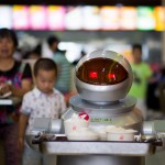 TO GO WITH STORY: CHINA -ROBOTS BY TOM HANCOCK This photo taken on August 13, 2014, shows a robot, carrying food to the customers in the robot restaurant in Kunshan. The robot restaurant opened on August 2, 2014 and the robots function as cooking machines, doormen and waiters.