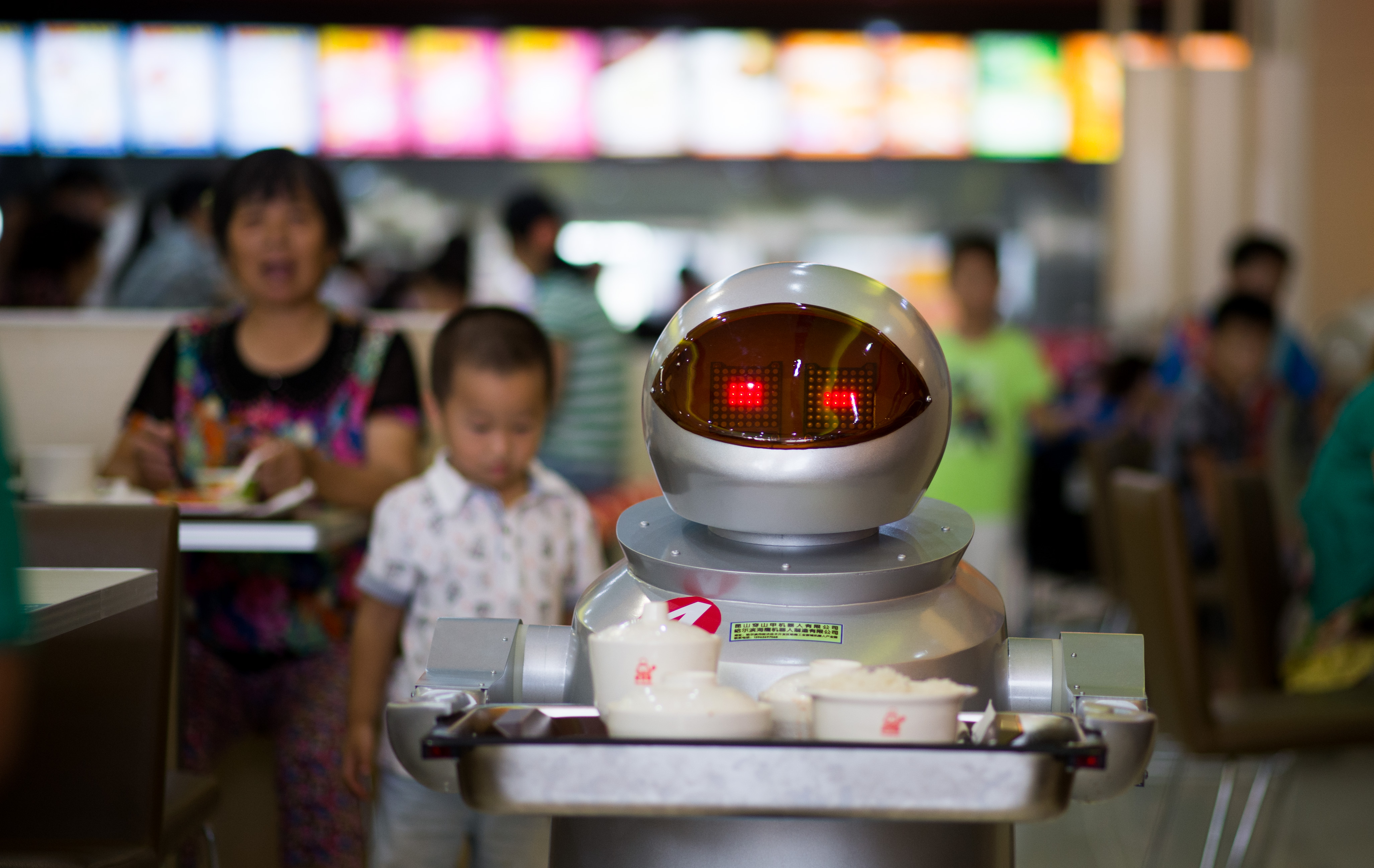 TO GO WITH STORY: CHINA -ROBOTS BY TOM HANCOCK This photo taken on August 13, 2014, shows a robot, carrying food to the customers in the robot restaurant in Kunshan. The robot restaurant opened on August 2, 2014 and the robots function as cooking machines, doormen and waiters.